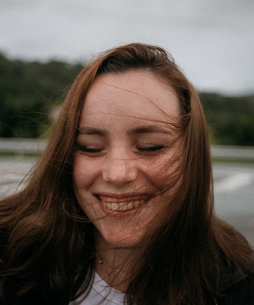 Content woman with eyes closed, feeling peaceful and refreshed.